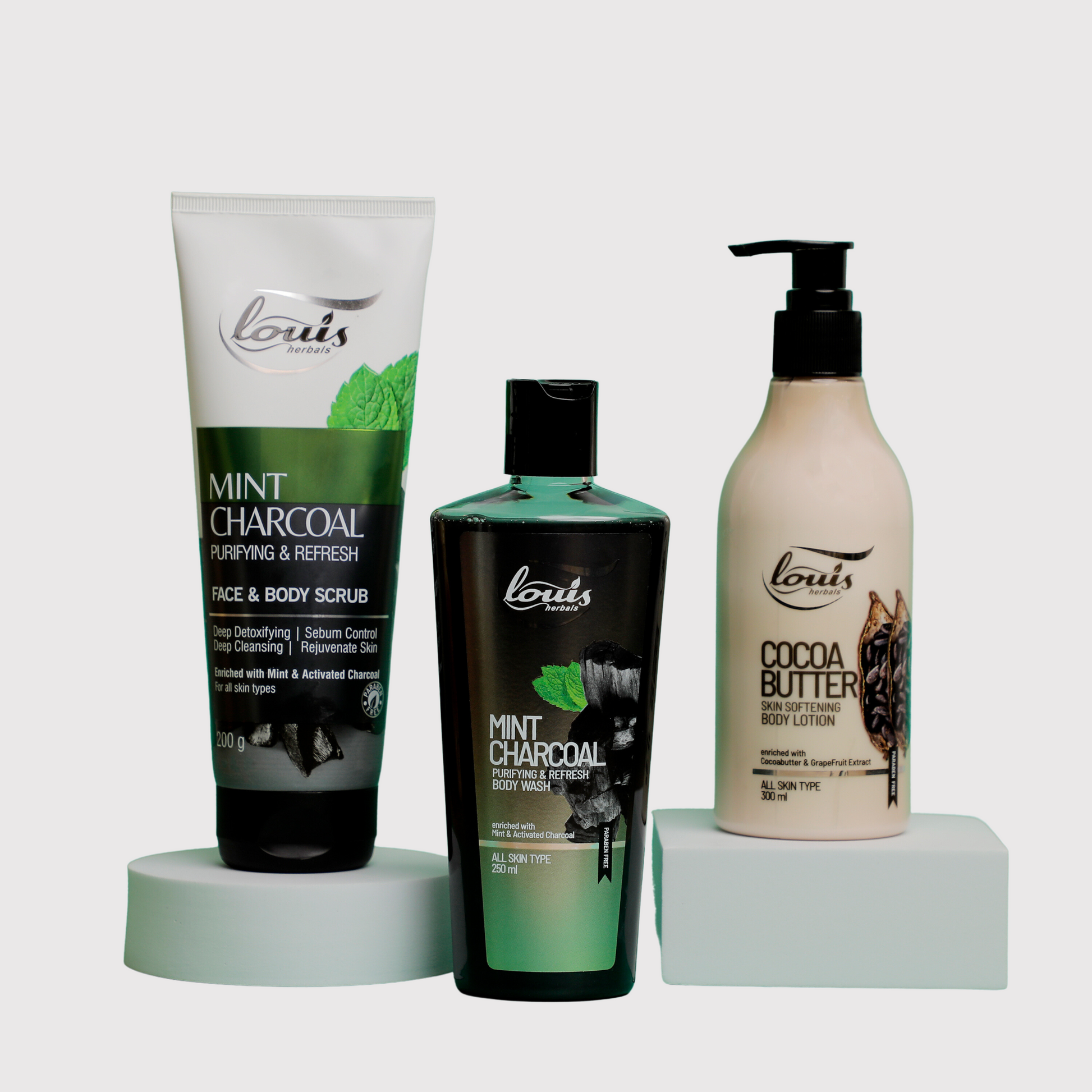 A set of three Louis Herbals Body Care Combo for Dry Skin with Face & Body Scrub, Body Wash & Cocoa Butter Lotion to exfoliate, cleanse, and deeply hydrate skin.
